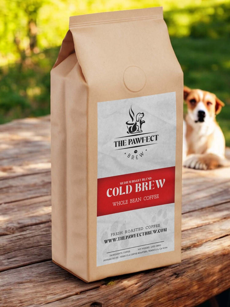 Paper bag of Cold Brew whole bean coffee from The Pawfect Brew, featuring a rustic setting and a dog in the background.