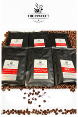 Best Sellers Sample Pack Ground Coffee featuring six varieties of premium coffee in black packaging over coffee beans.